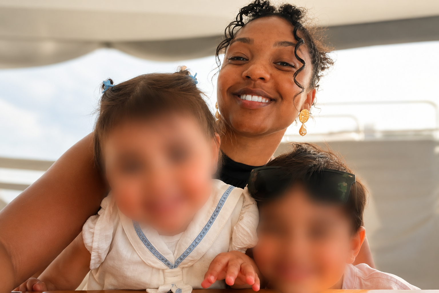 The House of Ease founder smiling with two children in her care